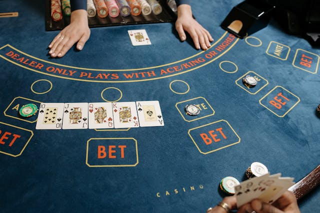 At Panalobet Casino, a professional player showing his cards and holding his bet at the casino table.